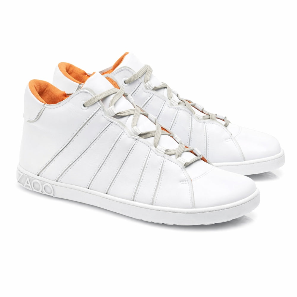 Die QQQ Mid White Sneaker von ZAQQ präsentieren sich im High-Top-Design mit grauen Schnürsenkeln und orangefarbenem Innenfutter. Sie sind aus Premium-Nappaleder gefertigt, verfügen über ein markantes Zickzack-Muster an der Seite und eine dicke Sohle für mehr Stil und Komfort.